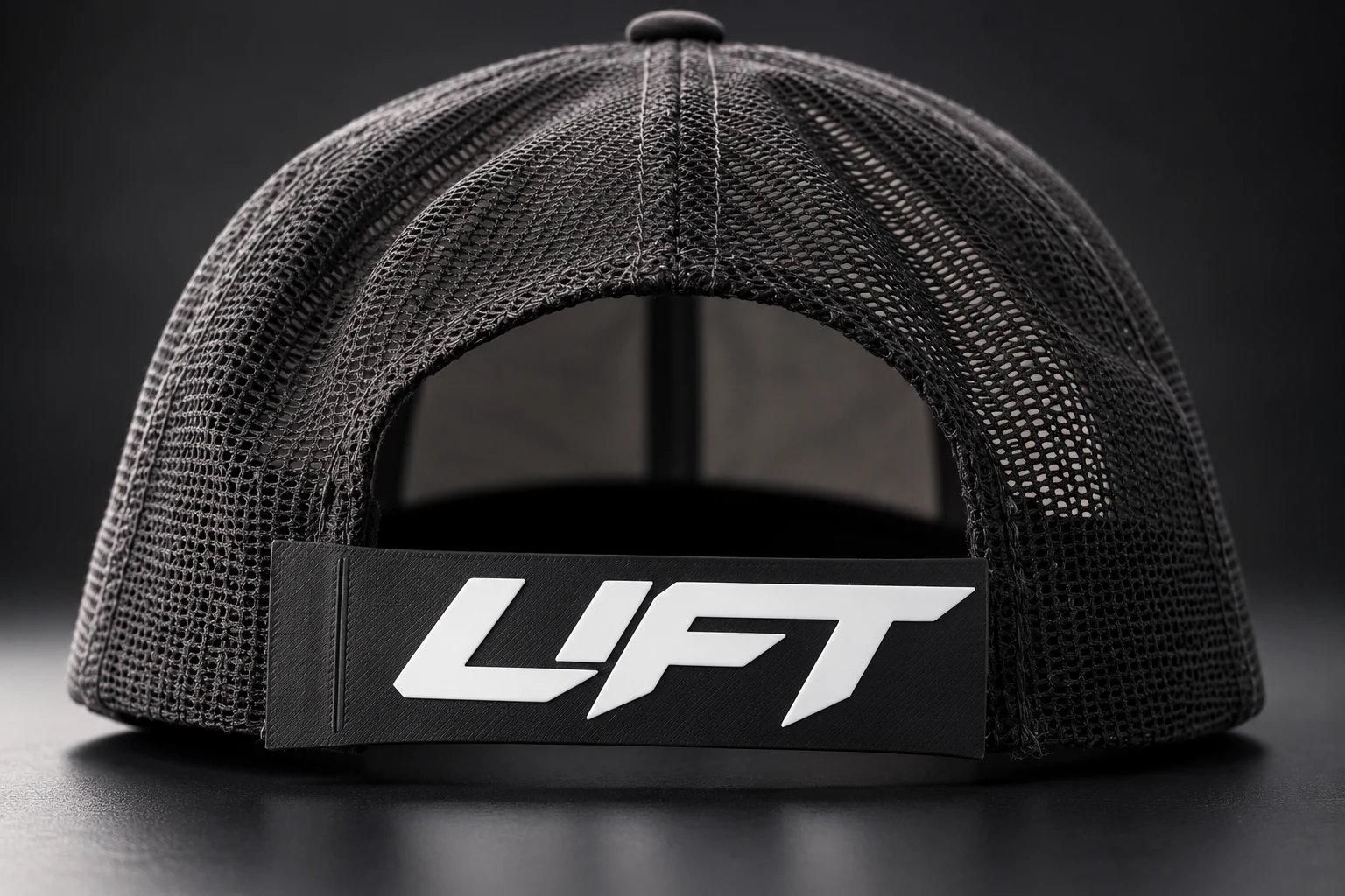 Rear view of a black mesh snapback with raised LIFT sleeve artwork