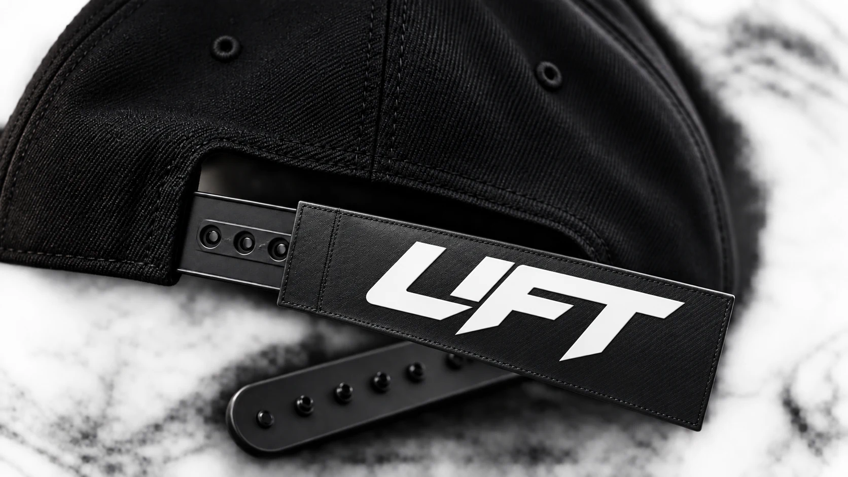 Sliding the SnapInk sleeve over a snapback strap