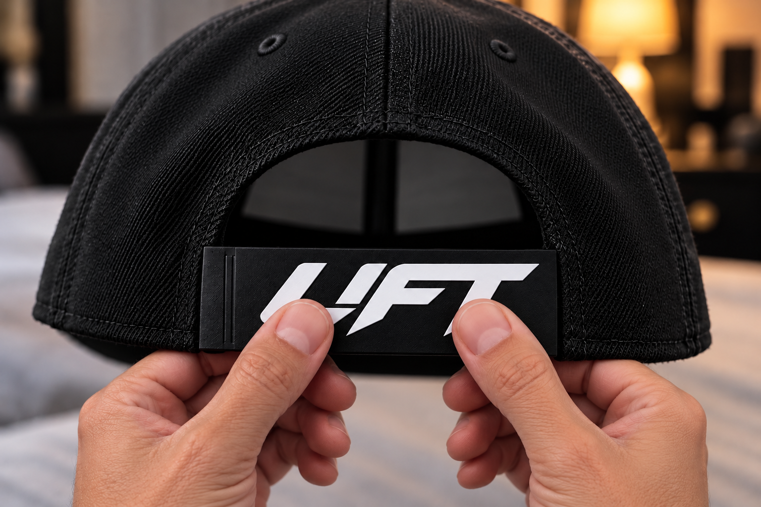 Snapping the SnapInk sleeve onto the rear strap of a snapback